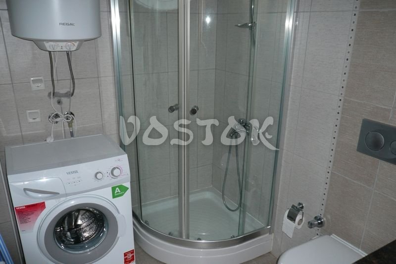 Bathroom is equipped with washing machine and shower cabin - Blue Green Apartments Calis Beach