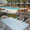 Terrace is equipped with table and chairs and overlooks to swimming pool - Blue Green Apartments in Calis Fethiye